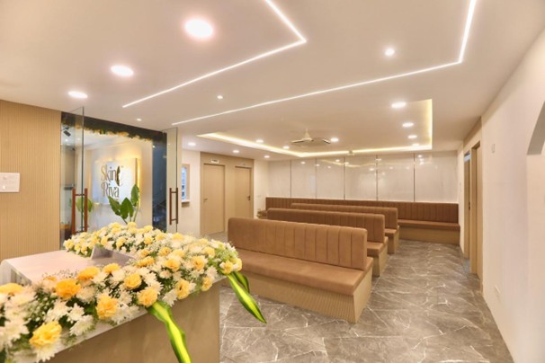 Spacious waiting area with brand floral arrangement and warm lighting